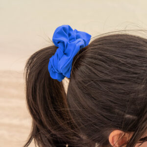 Model showcasing the scrunchies in bright blue