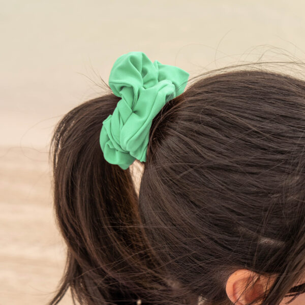 Model showcasing the scrunchies in lime