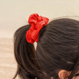 Model showcasing the scrunchies in red